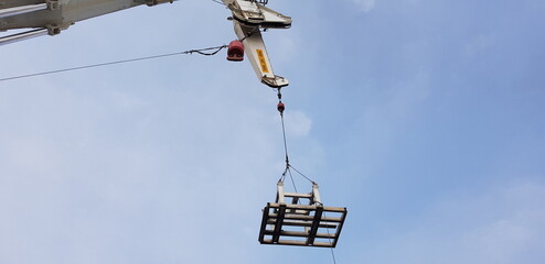 Crane lifts a metal frame 