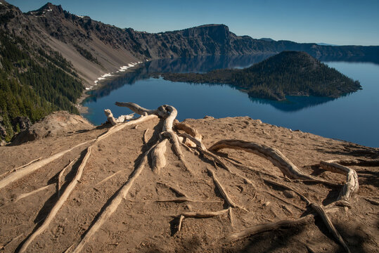 Panoramic view of the East side of blue Crater Lake from the Rim Village in the summer during the day, against cloudless, blue sky, Orgon, USA, featuring the Wizard Island
