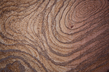 brown stone background with a pattern of concentric lines lines