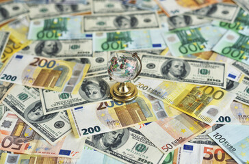 Globe on the desk and euro and dollar banknotes. Money and globus on the desk. Travel and money concept