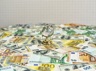 Globe on the desk and euro and dollar banknotes. Money and globus on the desk. Travel and money concept
