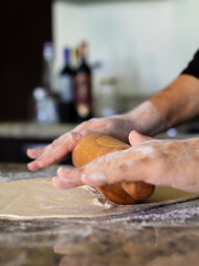 chef preparing and stretching pizza dough