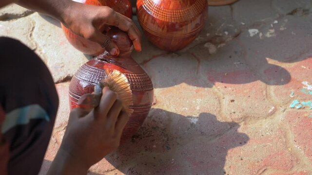Varnishing a decorative ornament by the roadside in Bangladesh.  This is the finishing touch applied just outside the store.