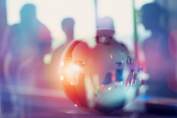 Modern background of blurred business people with a glass globe