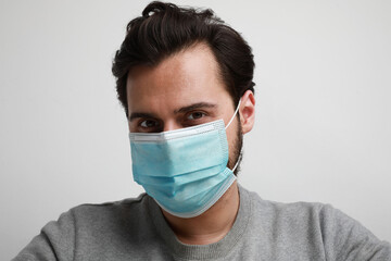 Bearded man with a face mask protecting himself from virus epidemic and other diseases.