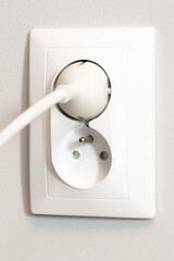 white electrical outlet with plug