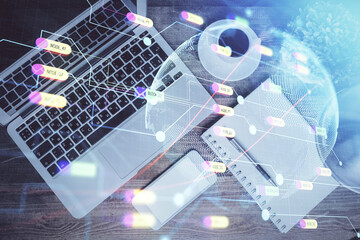 Double exposure of map hologram drawing over study table background with computer. Concept of international network. Top view.