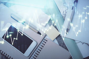Fototapeta premium Multi exposure of forex graph hologram over desktop with phone. Top view. Mobile trade platform concept.