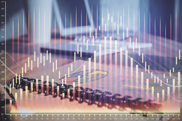 Double exposure of financial graph drawings and desk with open notebook background. Concept of forex market