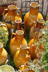 Large ochre amphora urns in Alberobello