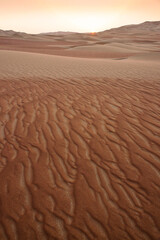 Sunset behind the sand dunes of Liwa, Abu Dhabi, United Arab Emirates