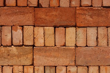 Red brick on the pallet. Texture. Close up