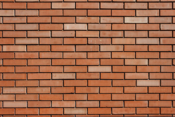 Naklejka premium Brick wall background. The texture of a decorative brick is brown. Close-up. 