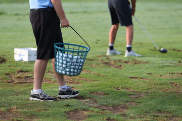golf balls are being resupplies at a golf practice facility
