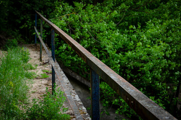 OLD METAL RAILING OVER THE CLIFF