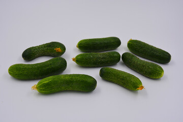 Young juicy cucumbers, Ukrainian cucumber harvest arranged on a white background. Fresh vegetables, healthy food for every day.