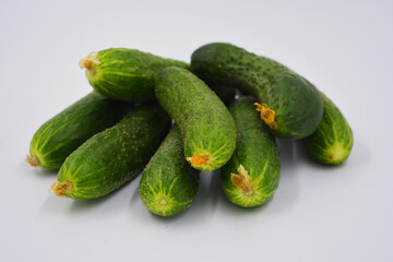 Young juicy cucumbers, Ukrainian cucumber harvest arranged on a white background. Fresh vegetables, healthy food for every day.