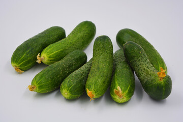 Young juicy cucumbers, Ukrainian cucumber harvest arranged on a white background. Fresh vegetables, healthy food for every day.