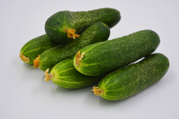 Young juicy cucumbers, Ukrainian cucumber harvest arranged on a white background. Fresh vegetables, healthy food for every day.