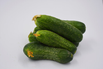 Young juicy cucumbers, Ukrainian cucumber harvest arranged on a white background. Fresh vegetables, healthy food for every day.