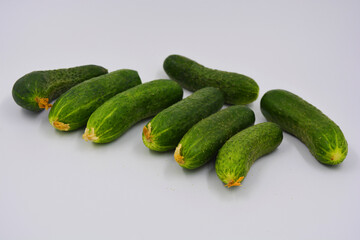 Young juicy cucumbers, Ukrainian cucumber harvest arranged on a white background. Fresh vegetables, healthy food for every day.