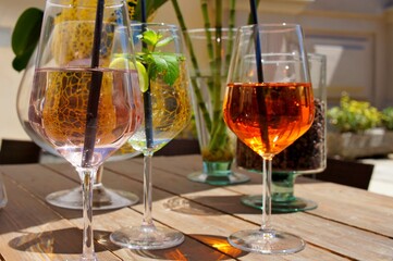 wine glasses  with cocktails on the wooden table close up