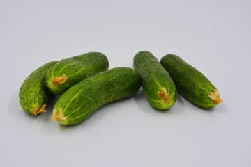 Young juicy cucumbers, Ukrainian cucumber harvest arranged on a white background. Fresh vegetables, healthy food for every day.