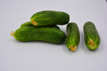 Young juicy cucumbers, Ukrainian cucumber harvest arranged on a white background. Fresh vegetables, healthy food for every day.