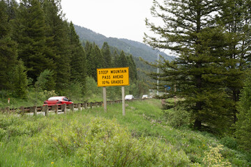 Sign warning drivers of Teton Pass, a steep mountain road with 10% grades, will close for snowstorms and dangerous conditions in winter