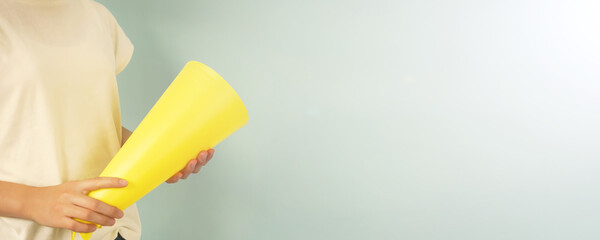 Woman cheering with a megaphone on a hot day.  暑い日にメガホンを持って応戦する人