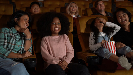 People audience watching movie in the movie theater cinema. Group recreation activity and...