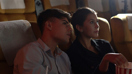 People audience watching movie in the movie theater cinema. Group recreation activity and...