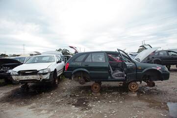 Fototapeta na wymiar Melbourne, Victoria / Australia - July 18 2020: Old wrecked cars in junkyard. Car recycling.