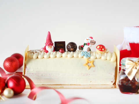 Santa White Log Cake with Cute Toppings. Cute Christmas Log Cake. Red Velvet Christmas Swiss Roll.