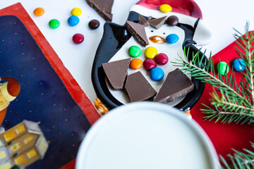 Chocolate sweets and milk with christmas accessories