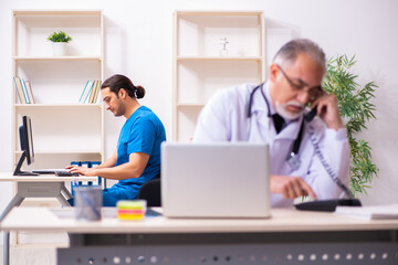 Two male doctors working in the clinic