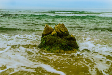 Large boulder at water edge