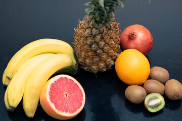 Exotic fruits on dark background, low key mood