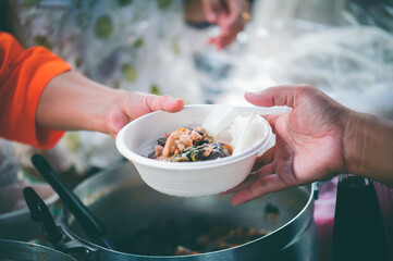 The concept of feeding : Receiving food for the poor from volunteers