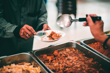 Homeless people wait to receive food donations from donors : The concept of poverty