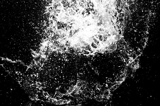 Motion blur of splash of water in the dark for use in advertising images.