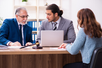 Young woman in courthouse with judge and lawyer