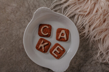Alphabet Biscuits with "cake" letters Cracker isolated on light background.