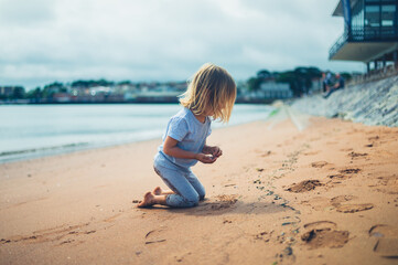 Preschooler boy playing on the beach