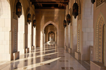 The contemporary architecture of Sultan Qaboos Grand Mosque in Muscat, Oman, is enhanced by dramatic corridors and colonnades.