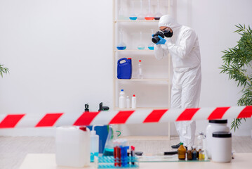 Young male chemist working in medicine lab