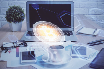 Double exposure of blockchain and crypto economy theme hologram and table with computer background....