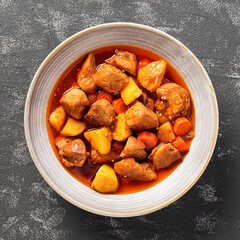 Pork meat stewed with potatoes, carrots and spices (hungarian goulash).