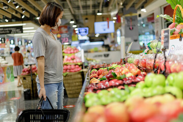 Asian woman wearing medical mask shopping