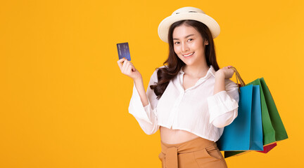 Asian woman holding creadit card and shoppingbag with mid year sale.